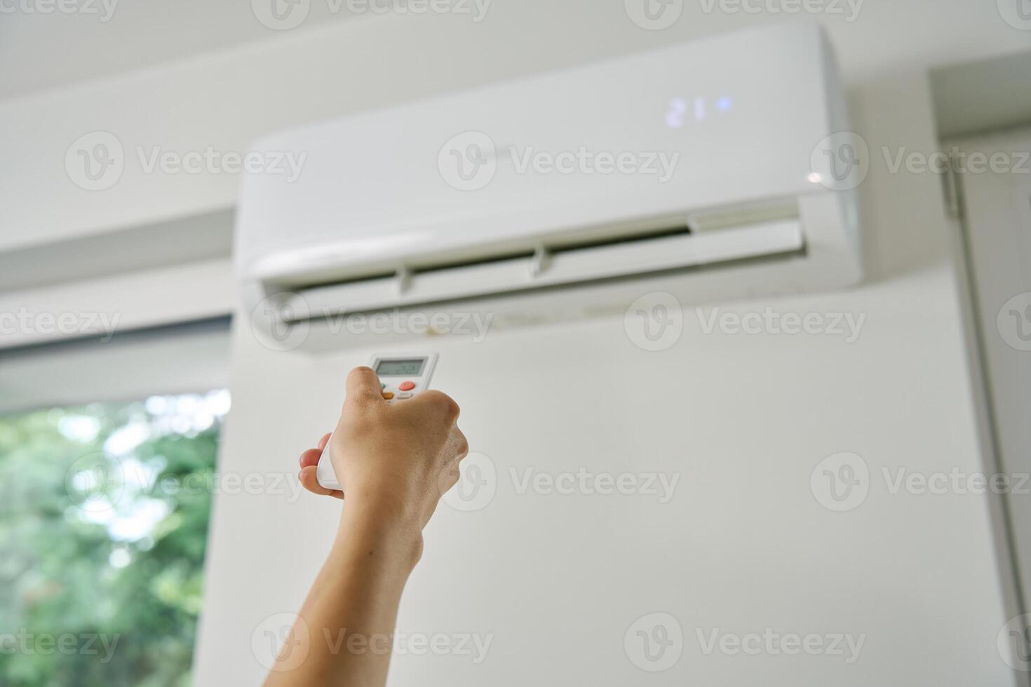 Adjusting Air Conditioner Temperature with Remote Control photo