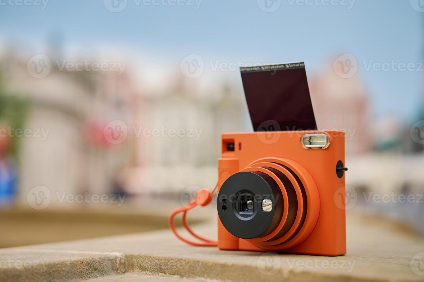 Vintage Orange Instant Camera. Travel shooting equipment photo