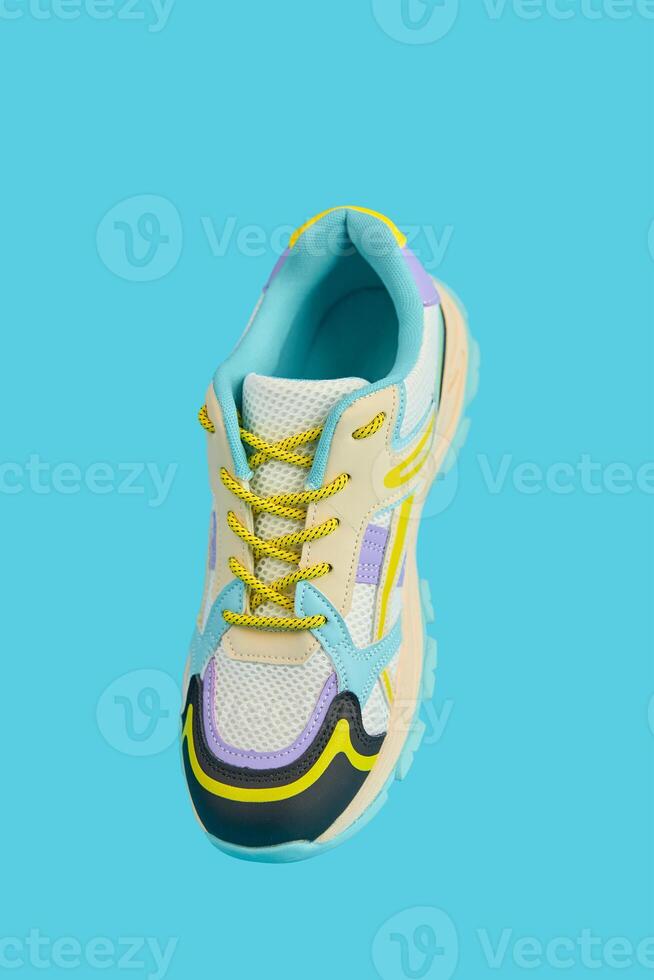 Fashionable Sneaker on blue background. Creative banner with stylish shoes photo