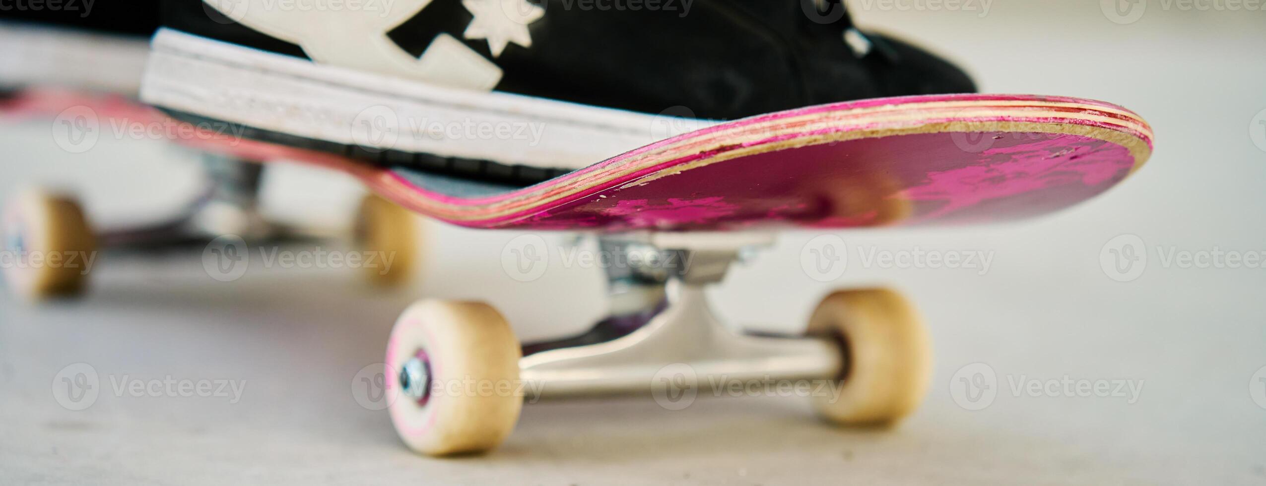 Close-Up of Skateboarder's Feet on Skateboard photo