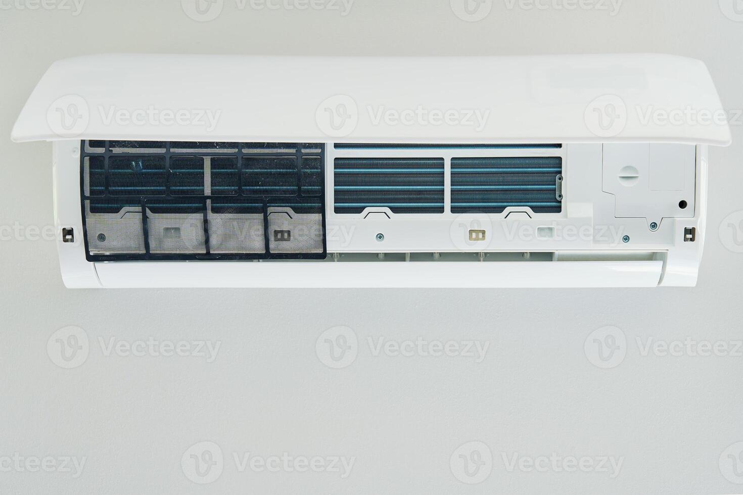 Air conditioner unit with opened front cover ready for maintenance photo