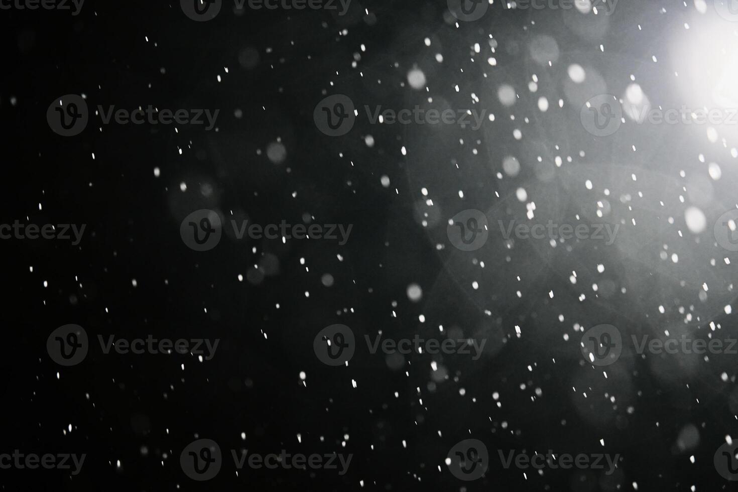 Falling snowflakes on dark background. photo