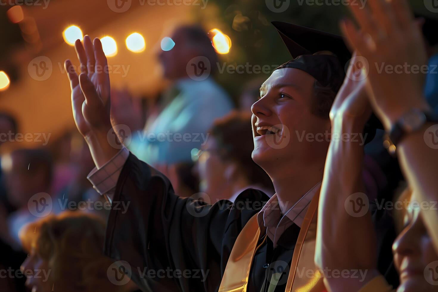 A young Caucasian man a graduate is waving He is happy and smiling photo