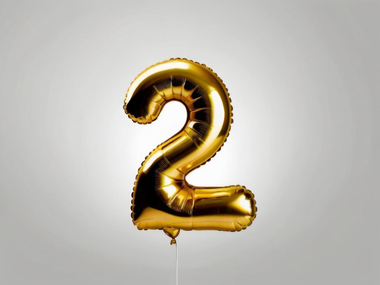 Golden Foil Balloon Number 2 on White Background for Celebratory Events photo