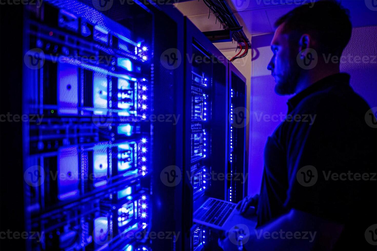 Man standing in front of a data centre checking the database photo