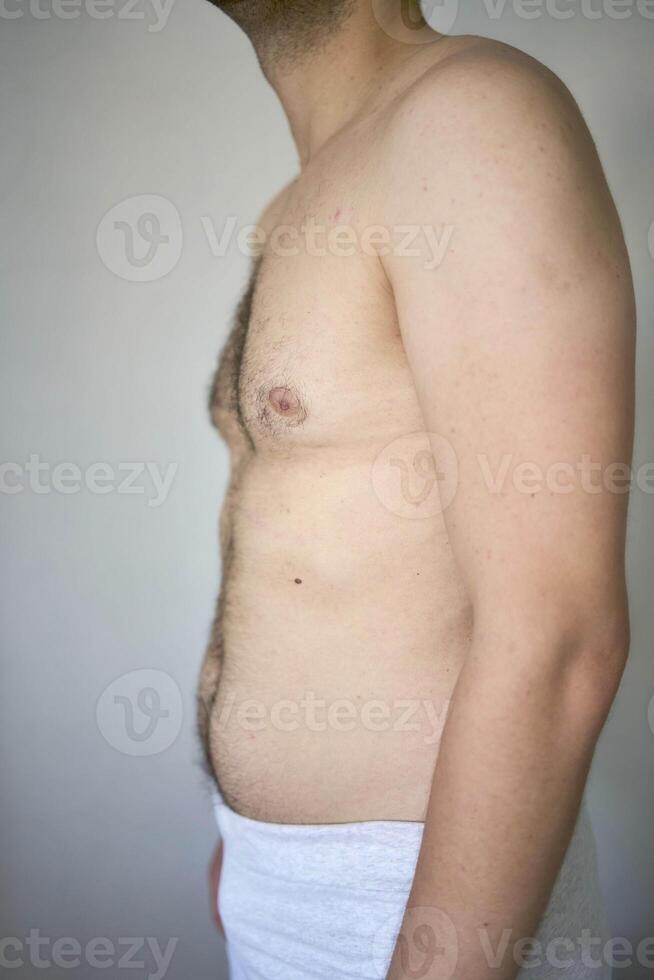 the side and stomach of a thirty-year-old man of average build photo