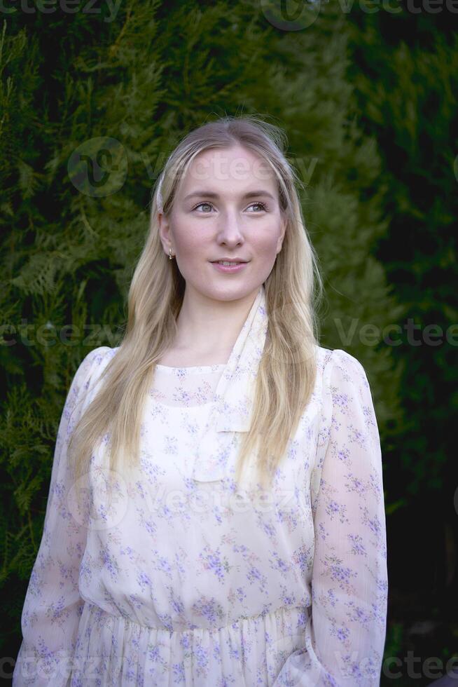 portrait of a young blonde woman in a pastel chiffon dress photo
