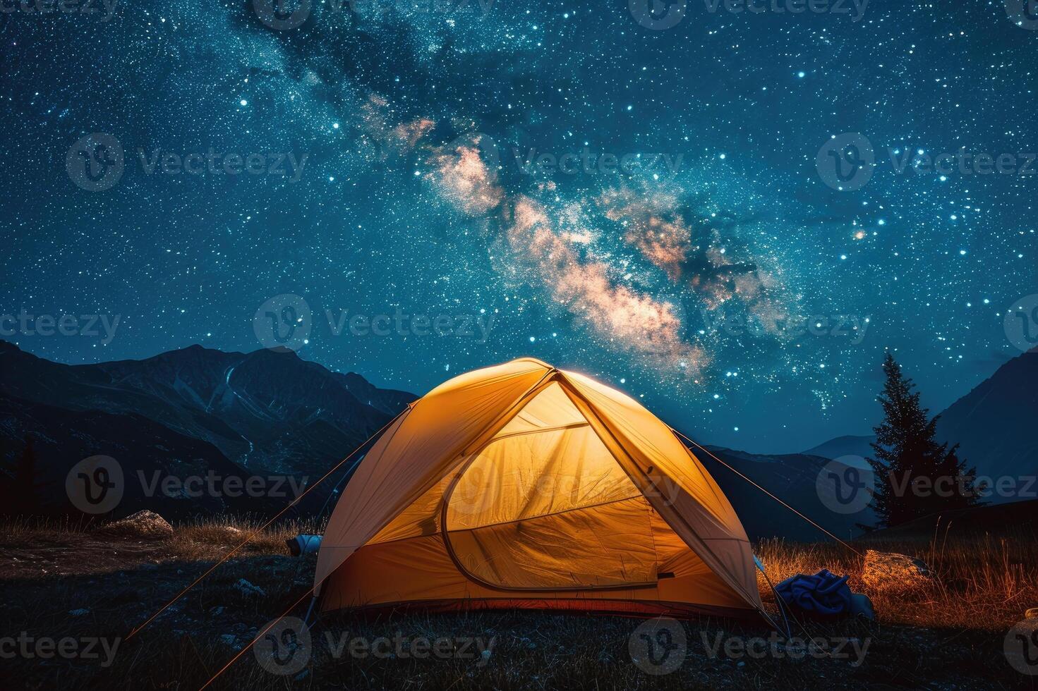 Illuminated tent under glowing night sky with stars and milky way. Tourist equipment for camping. photo