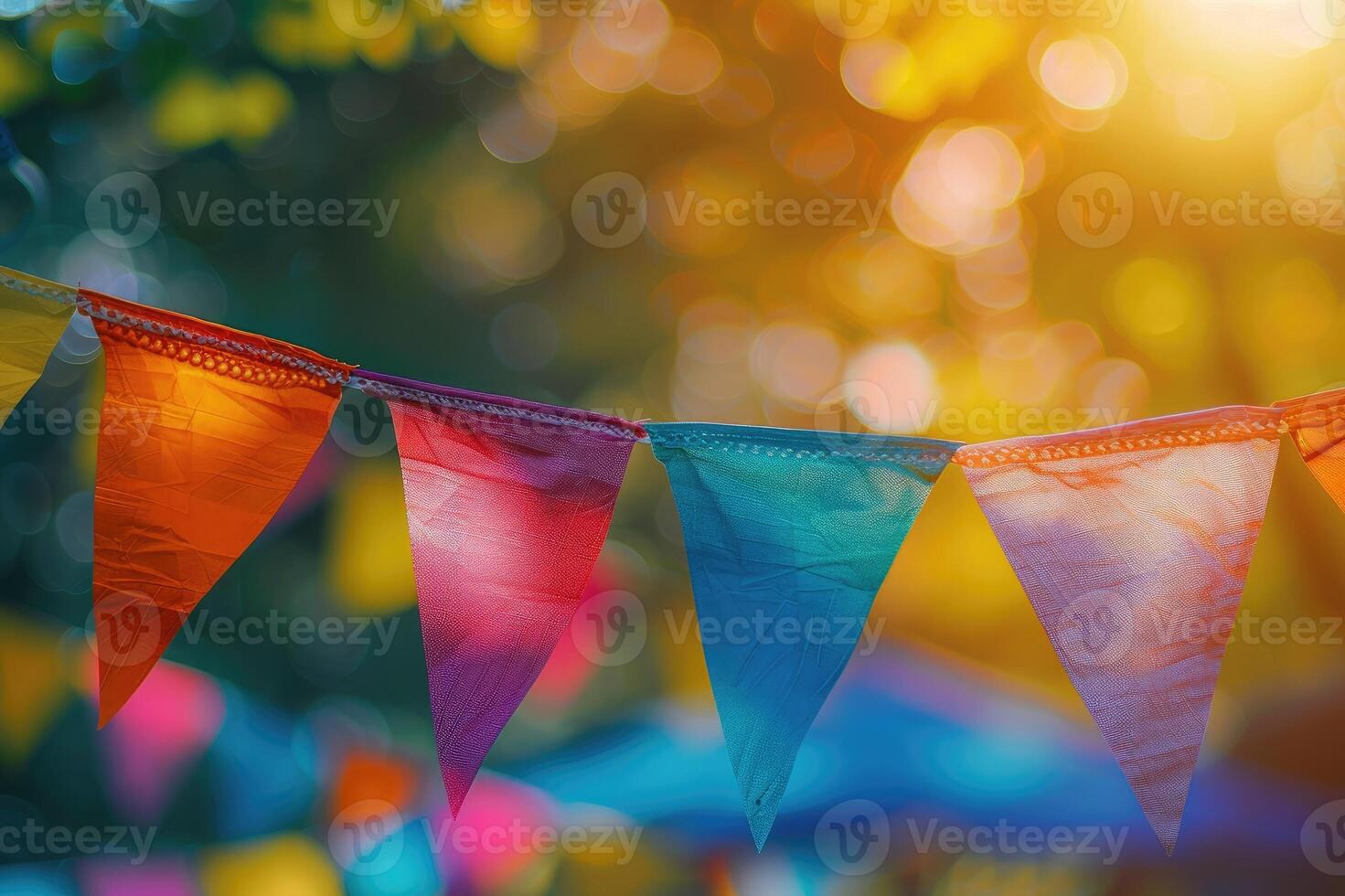 Festive colorful bunting flags strung across in golden hour sunlight creating a joyous atmosphere photo
