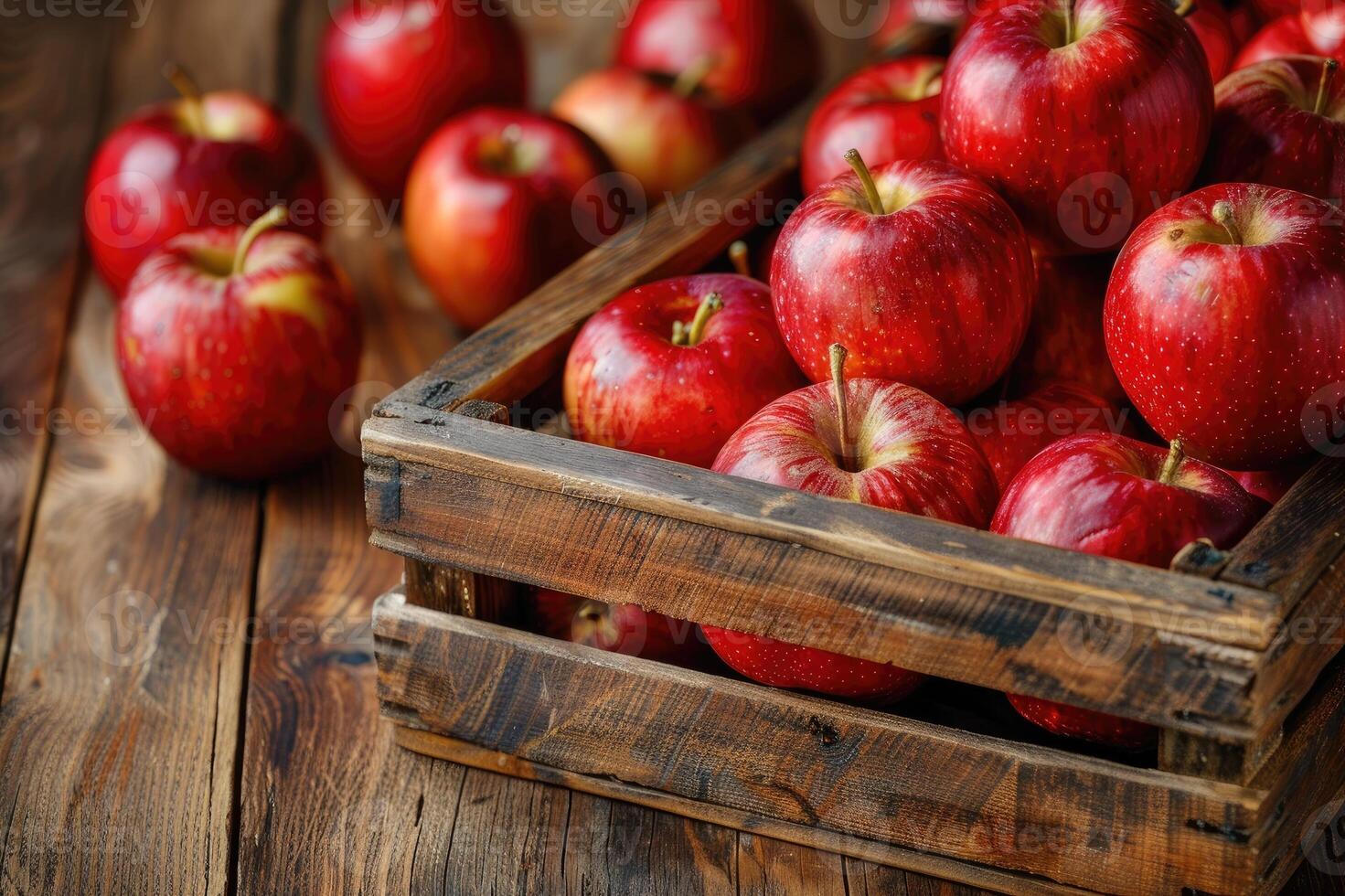 Red apples in a crate on rustic wood table. photo