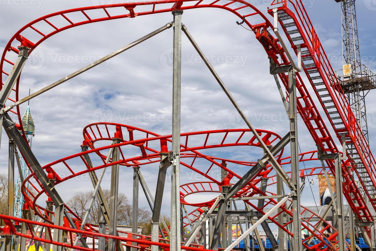a part of a looping roller coaster in an amusement park photo
