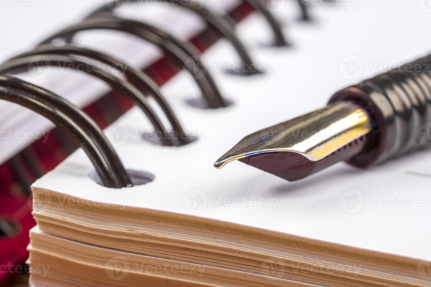 Classic fountain pen on a notebook, concept of taking notes. photo