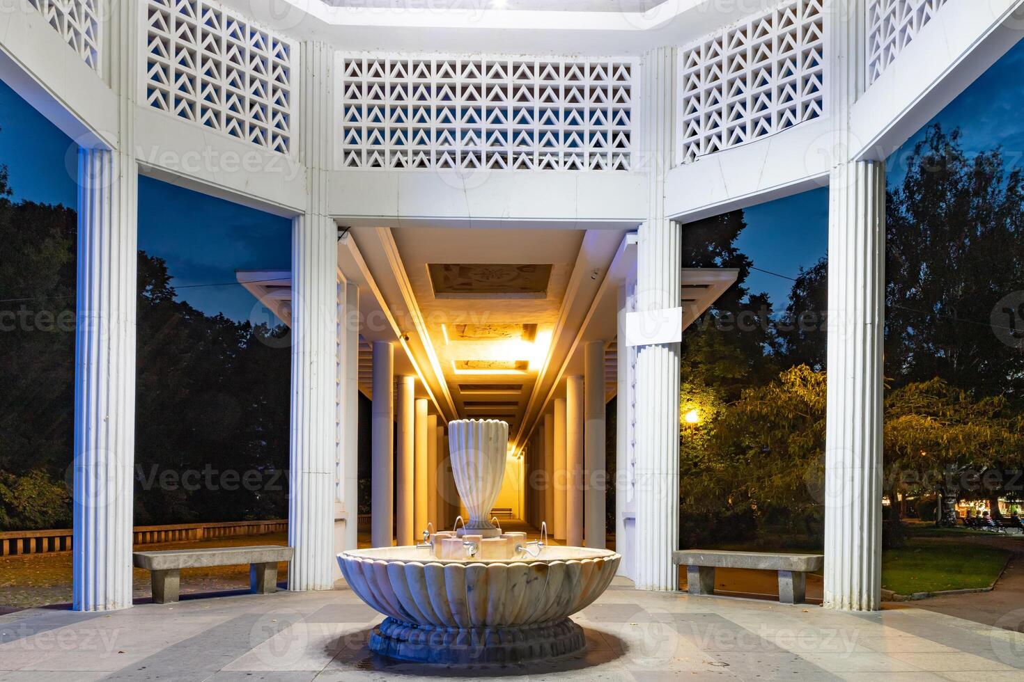 Fountain with mineral water under Roman columns in town of Hisarya, Plovdiv Region, Bulgaria at night photo