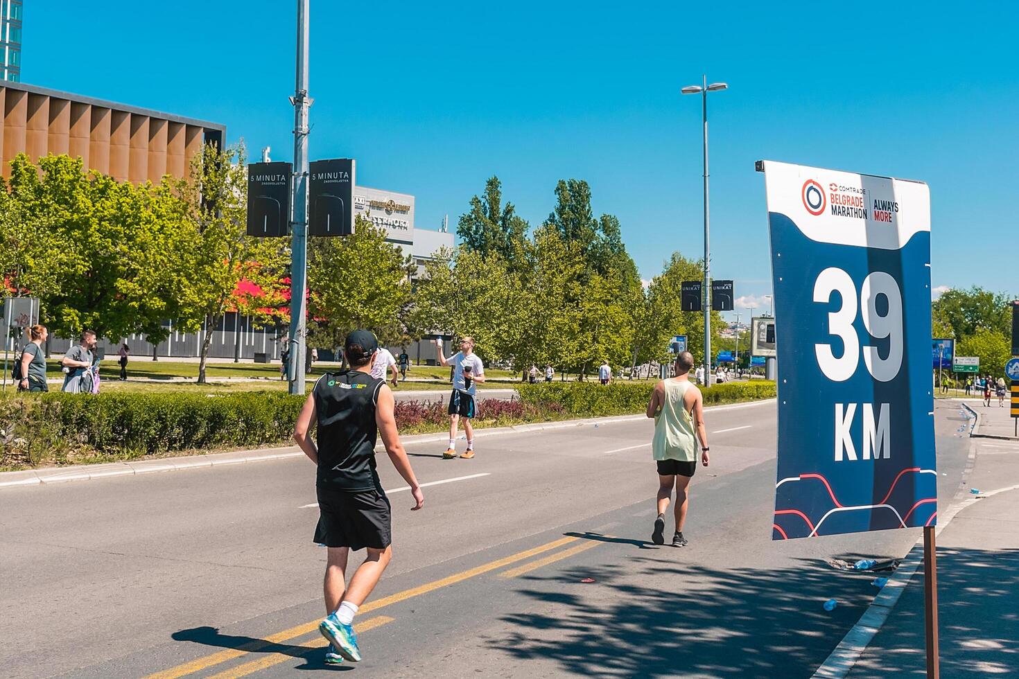 Belgrade, Serbia, April 28, 2024, 37th Belgrade Marathon Comtrade. People running a long distance marathon. Tired people runners looking for a second wind. photo