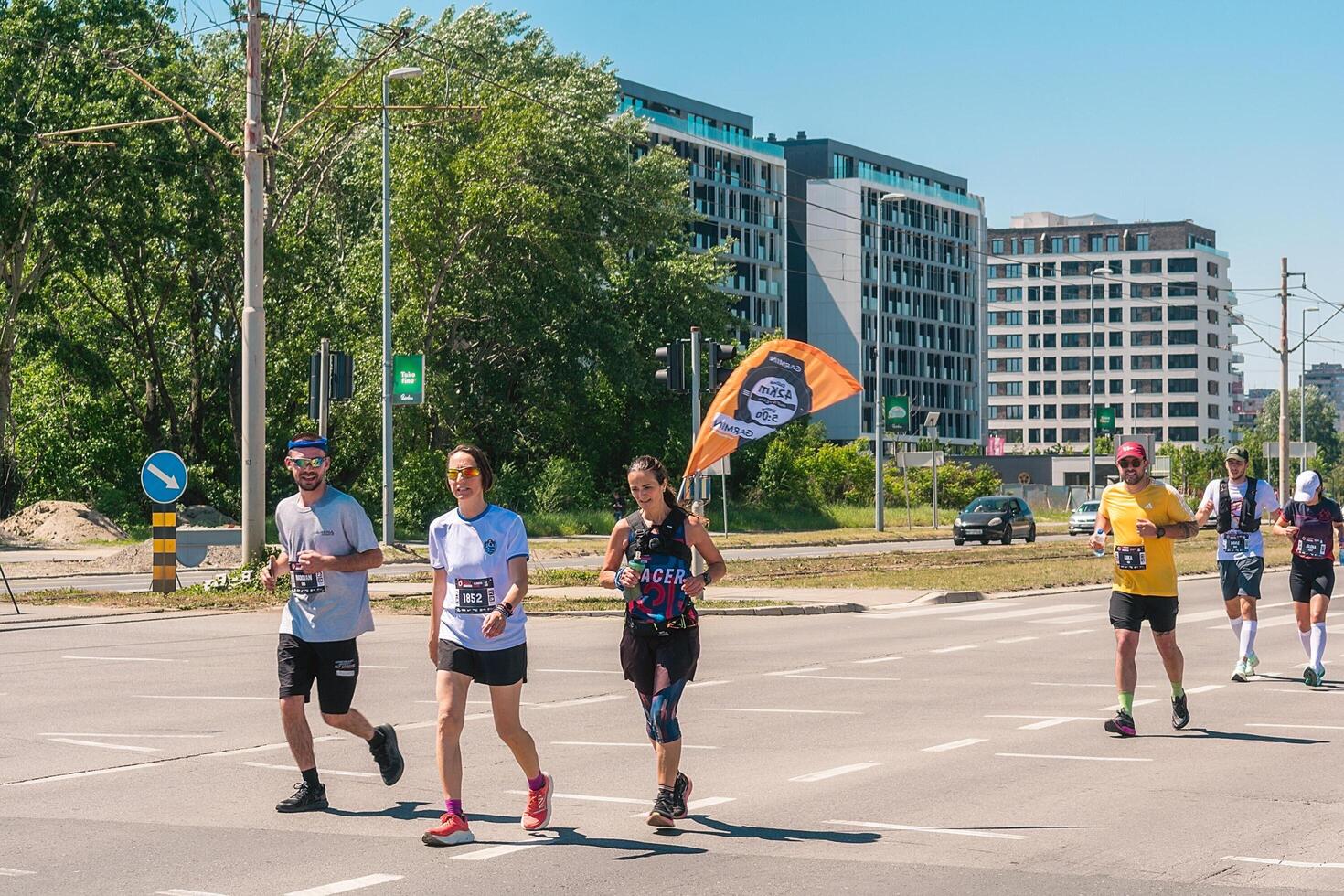 Belgrade, Serbia, April 28, 2024, 37th Belgrade Marathon Comtrade. People running a long distance marathon. Tired people runners looking for a second wind. photo
