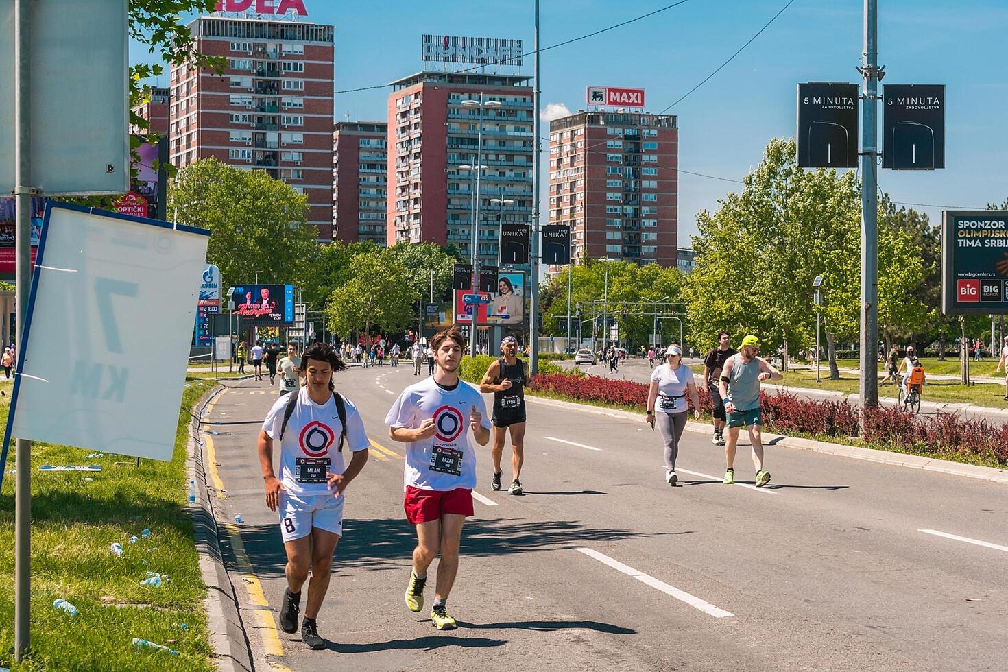 Belgrade, Serbia, April 28, 2024, 37th Belgrade Marathon Comtrade. People running a long distance marathon. Tired people runners looking for a second wind. photo