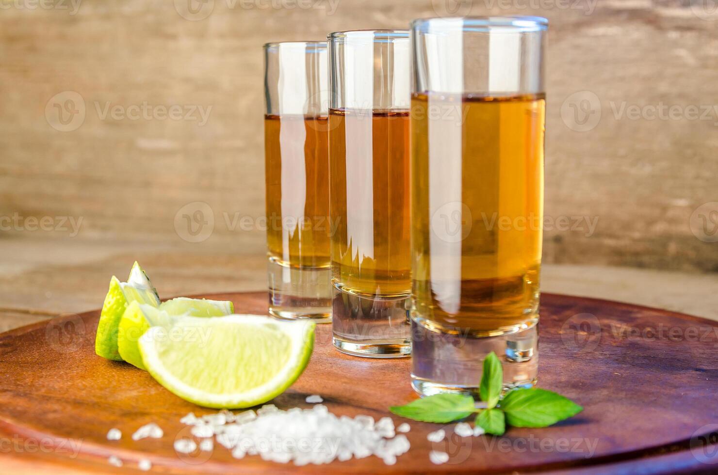 Glasses of tequila on the wooden board photo