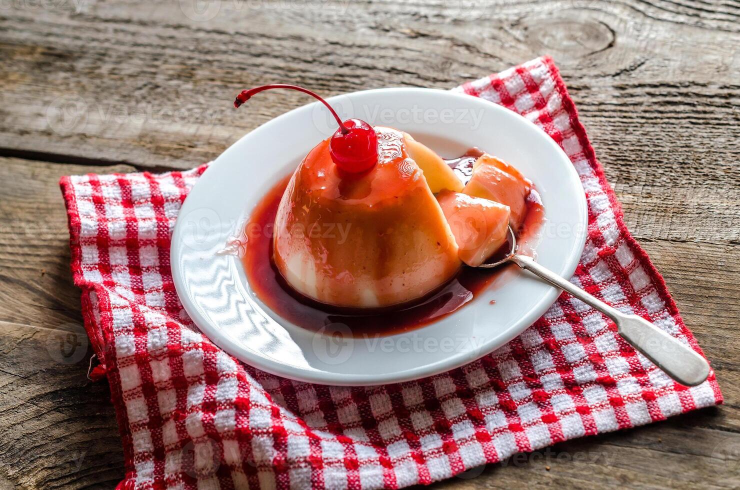 Panna cotta with berry sauce and maraschino cherry photo