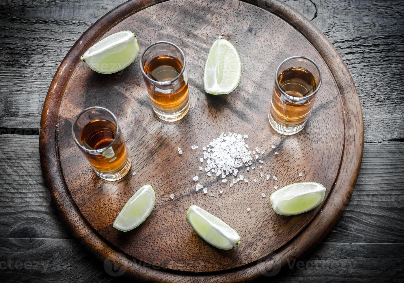 Glasses of tequila on the wooden board photo