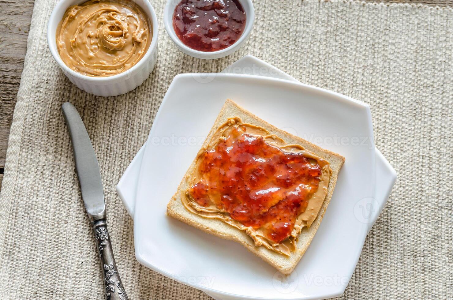 Sandwich with peanut butter and strawberry jelly photo