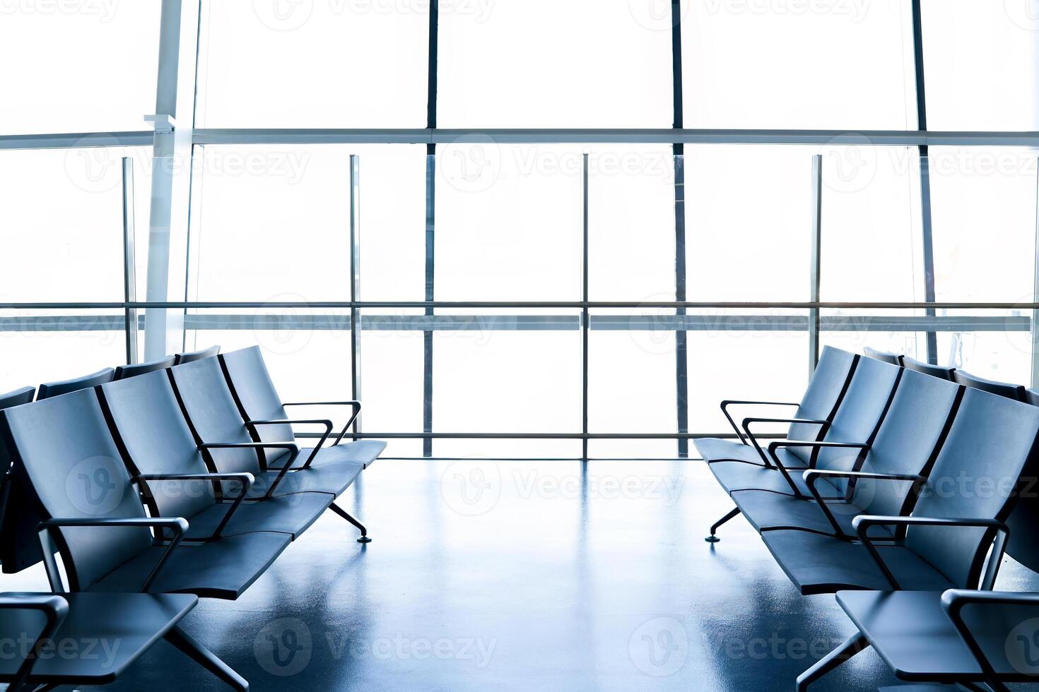 Departure lounge at the airport with seats in a row photo