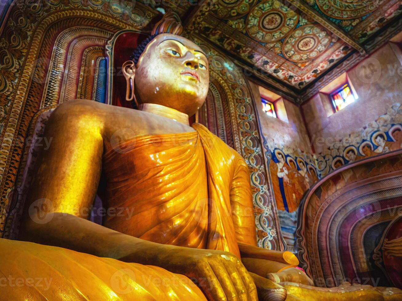 giant golden sitting buddha in Sri Lanka temple bottom view close up. Wewurukannala Buduraja Maha Viharaya temple photo