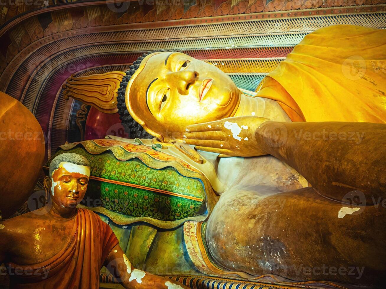 giant golden lying buddha in Sri Lanka temple bottom view close up. Wewurukannala Buduraja Maha Viharaya temple. photo