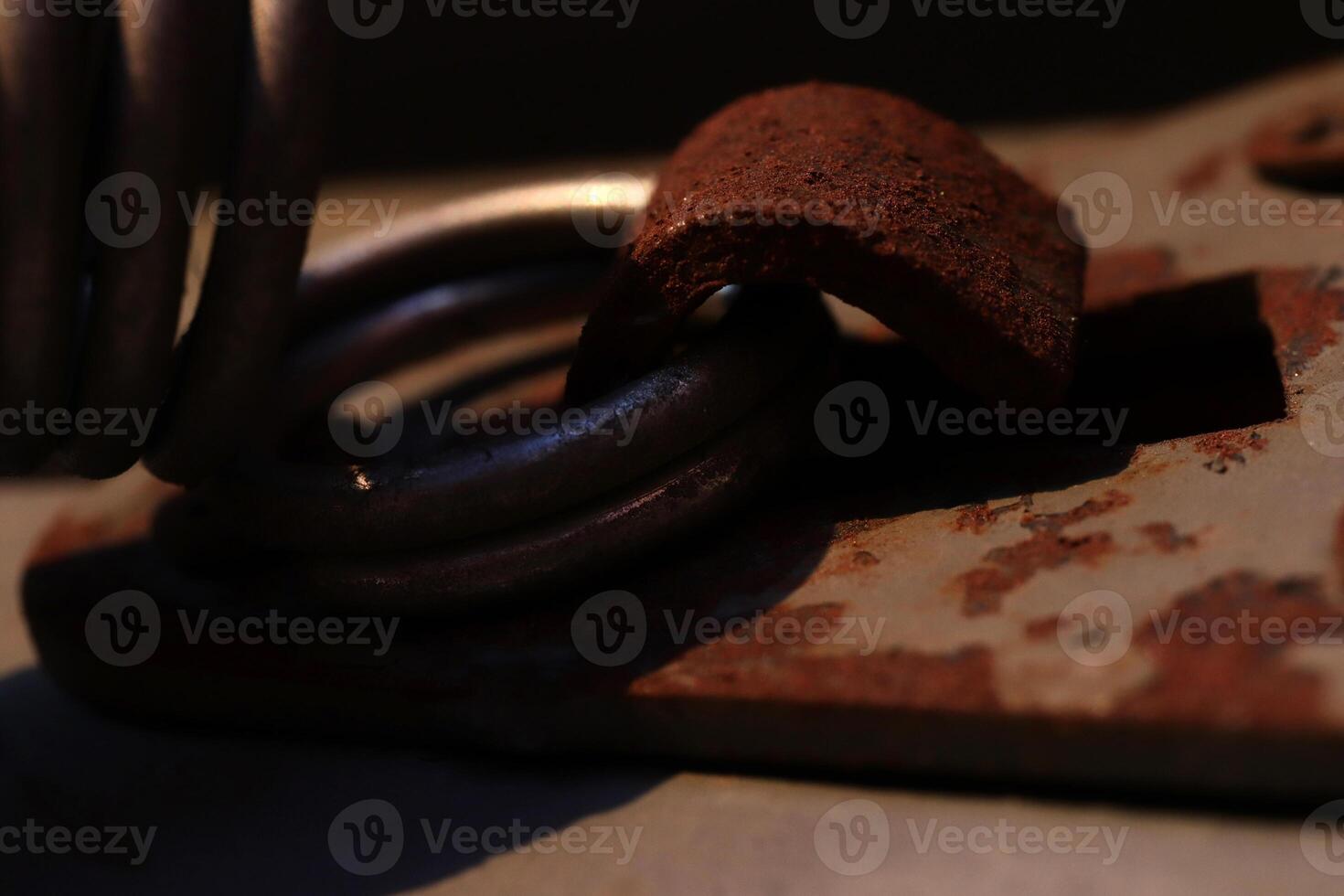 Rusty Metal Hook Holding Spring Ring. Sunshine Evening. Macro Closeup. photo