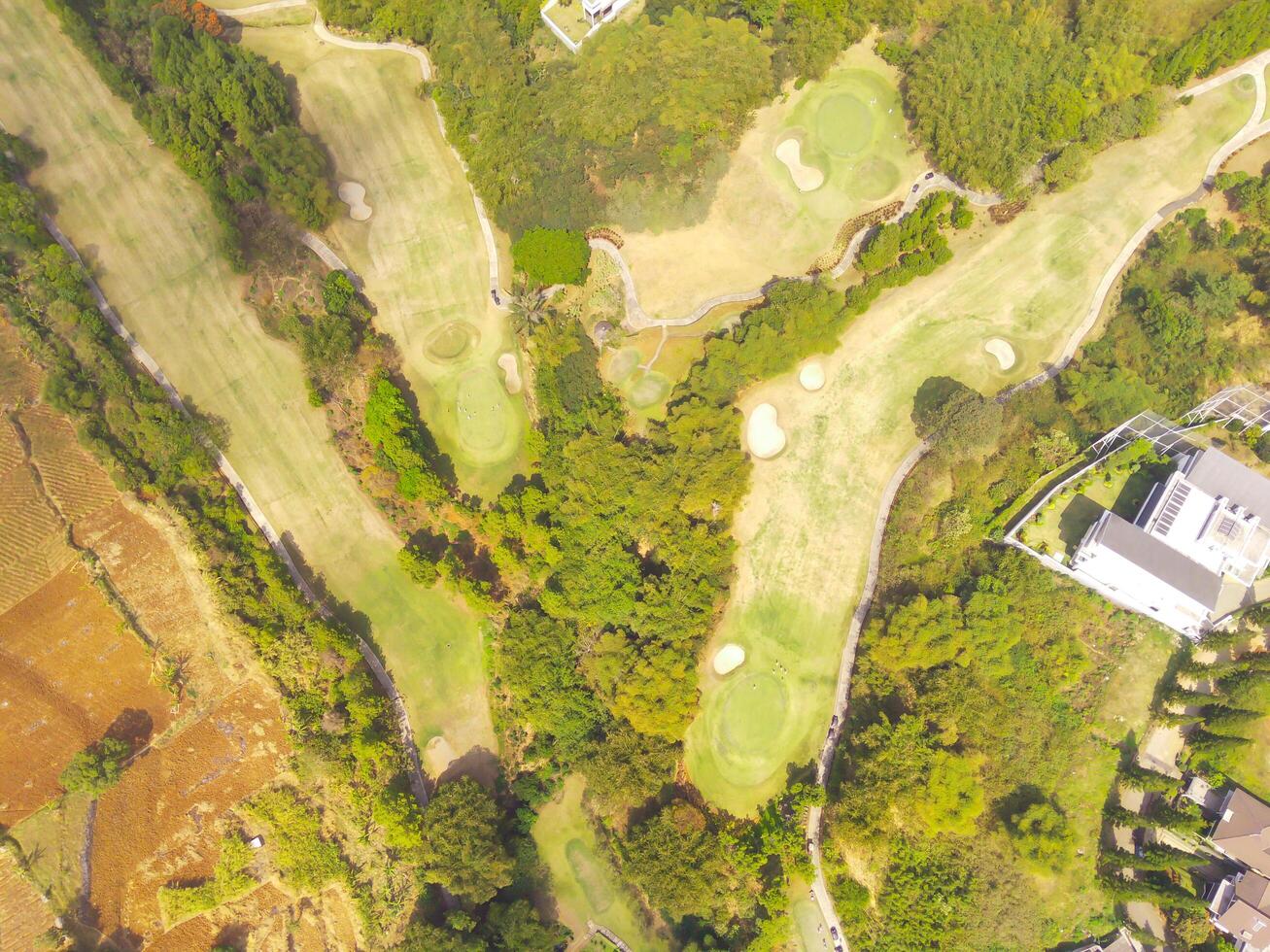 Bird's eye view of a Golf Courses area with cityscape and trees, Bojong Koneng - Bandung, Indonesia. Drone Photography, Aerial Photography, Landscape, Sport Fields, Green Field aerial photo