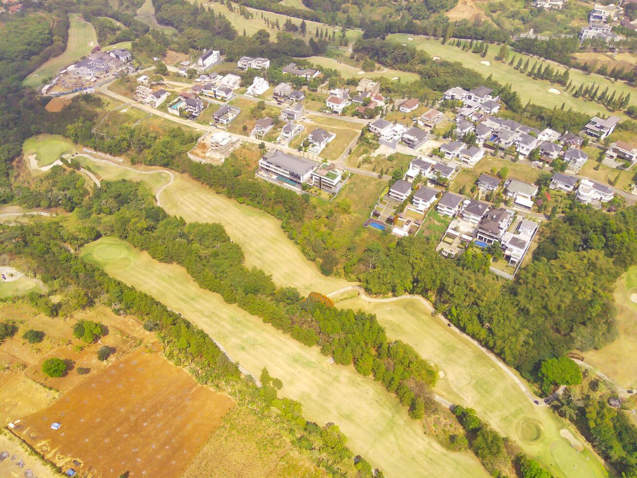 Bird's eye view of a Golf Courses area with cityscape and trees, Bojong Koneng - Bandung, Indonesia. Drone Photography, Aerial Photography, Landscape, Sport Fields, Green Field aerial photo