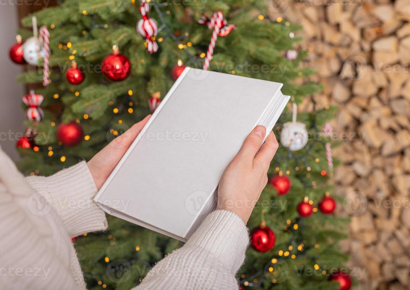 Christmas book mockup, winter cover. Blank mock up with white hardcover. Xmas tree in interior home. photo
