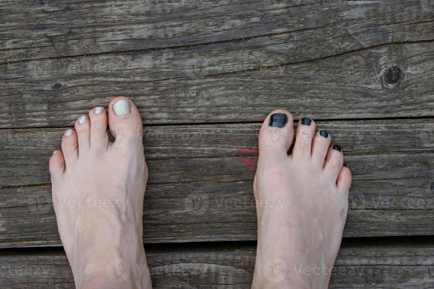 Female foot barefoot white pearlmutt nail polish hanging above water. Resting at the lake, sitting on the river beach. Relaxing at nature. Sky reflection. Vacation mood. Happy summer day. Top view photo