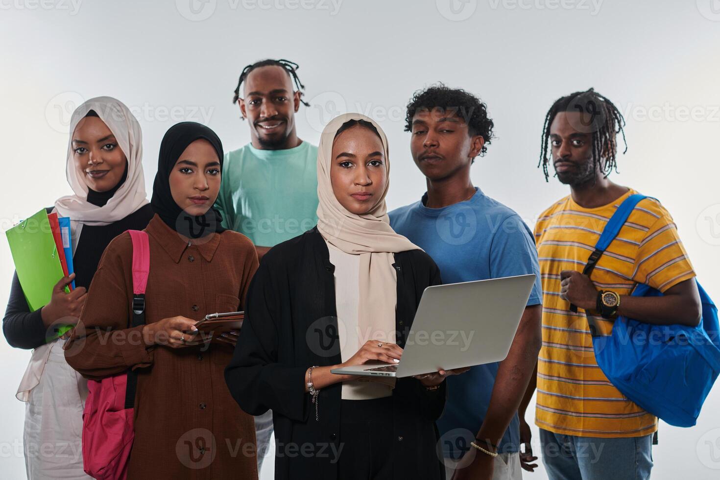 Group of diverse students engages in modern educational practices, utilizing a variety of technological tools such as laptops, tablets, and smartphones against a clean white background, exemplifying photo
