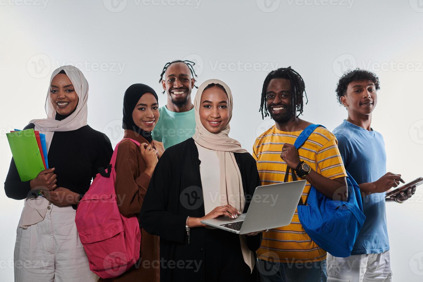 Group of diverse students engages in modern educational practices, utilizing a variety of technological tools such as laptops, tablets, and smartphones against a clean white background, exemplifying photo