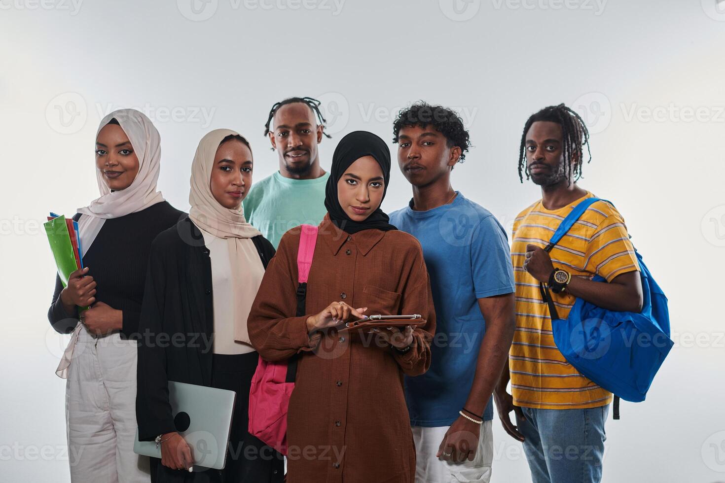Group of diverse students engages in modern educational practices, utilizing a variety of technological tools such as laptops, tablets, and smartphones against a clean white background, exemplifying photo
