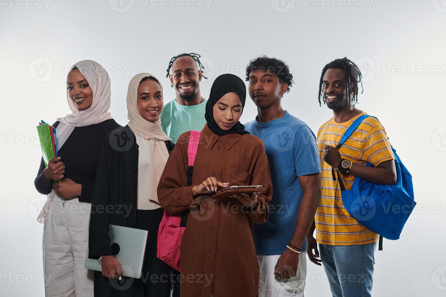 Group of diverse students engages in modern educational practices, utilizing a variety of technological tools such as laptops, tablets, and smartphones against a clean white background, exemplifying photo