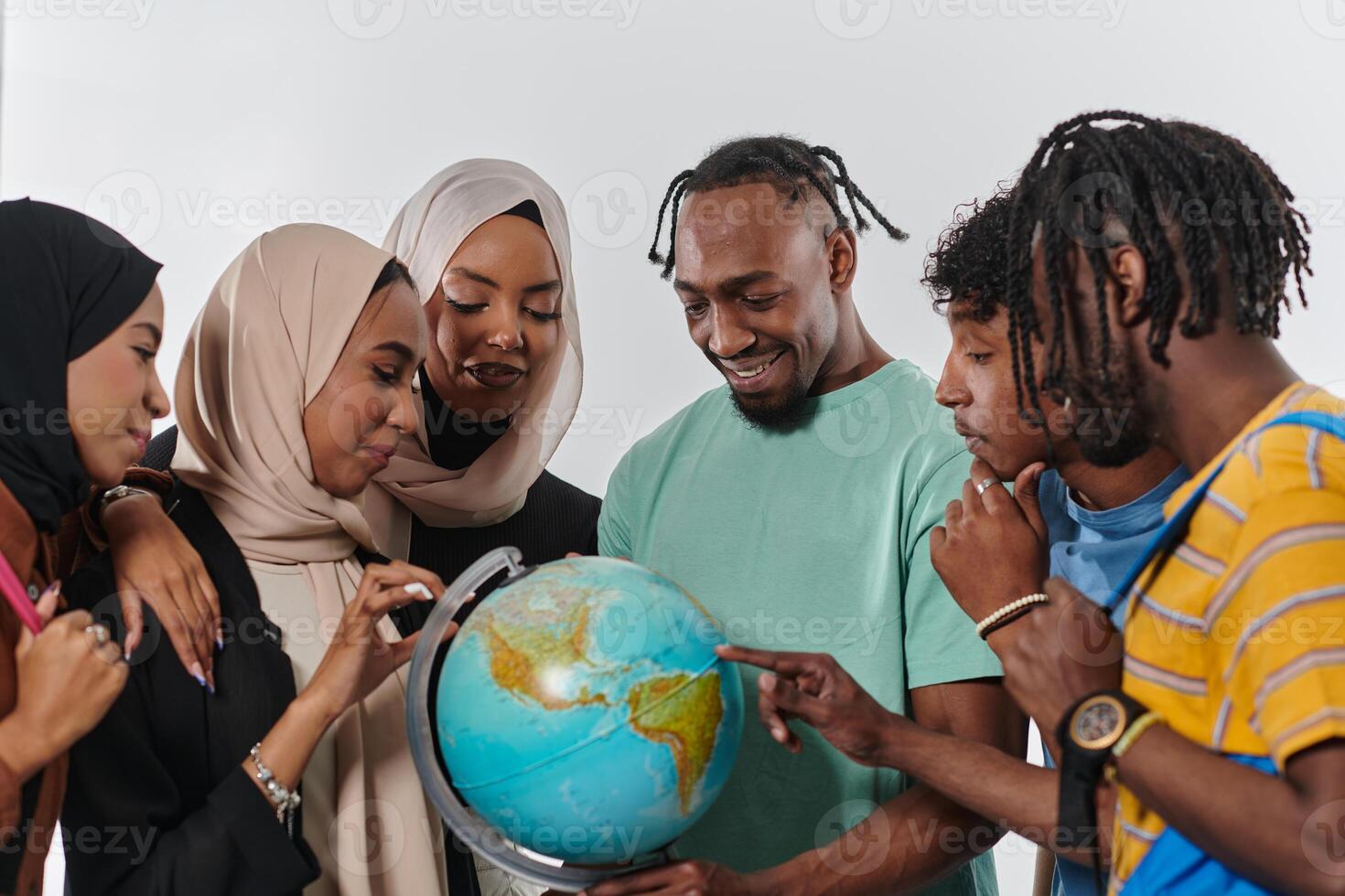 A diverse group of students is gathered around a globe, engrossed in exploration and study, their vibrant energy captured against a pristine white background, symbolizing unity and curiosity in their photo