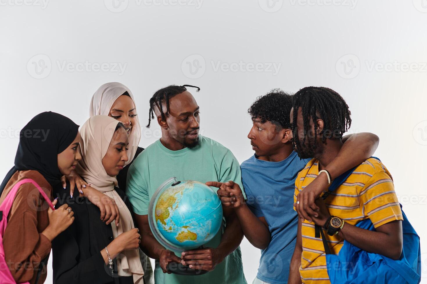 A diverse group of students is gathered around a globe, engrossed in exploration and study, their vibrant energy captured against a pristine white background, symbolizing unity and curiosity in their photo