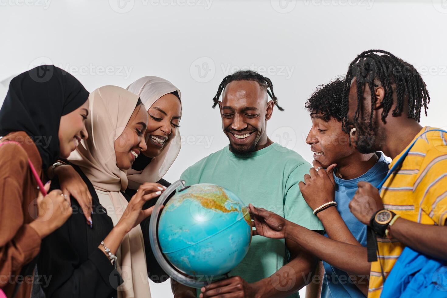 A diverse group of students is gathered around a globe, engrossed in exploration and study, their vibrant energy captured against a pristine white background, symbolizing unity and curiosity in their photo