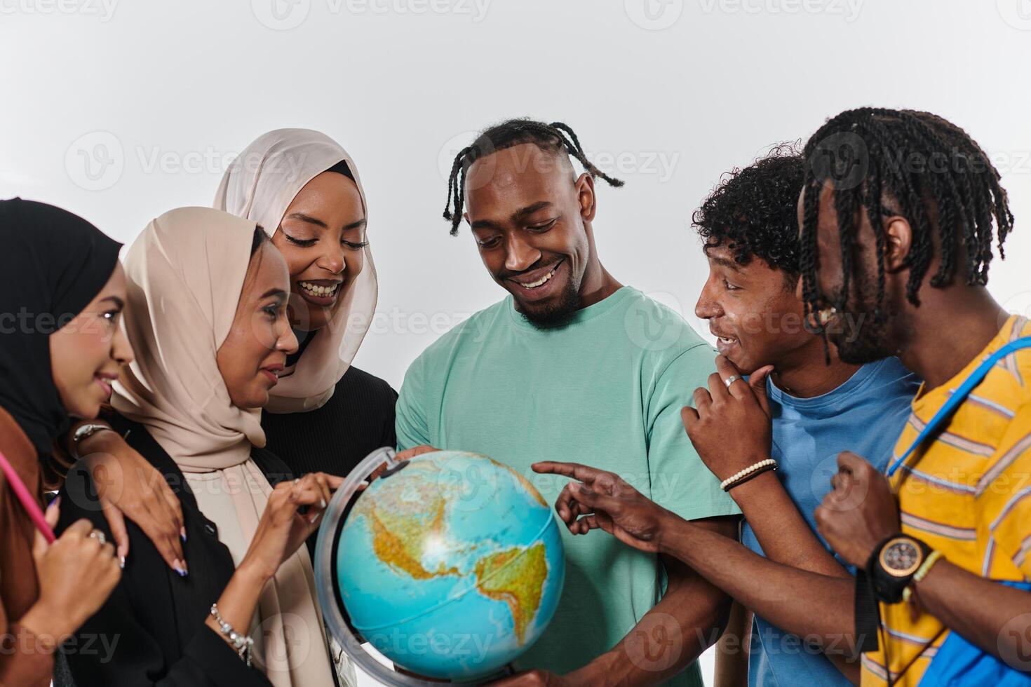 A diverse group of students is gathered around a globe, engrossed in exploration and study, their vibrant energy captured against a pristine white background, symbolizing unity and curiosity in their photo