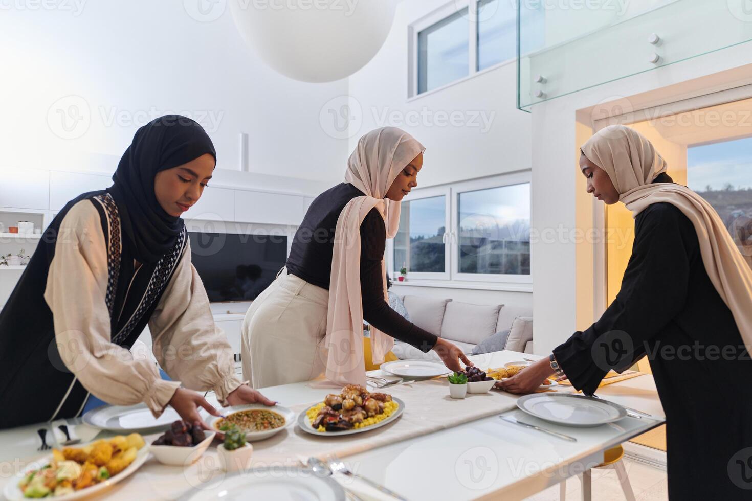 Group of young Arab women come together to lovingly prepare an iftar table during the sacred Muslim month of Ramadan, embodying the essence of communal unity, cultural tradition, and joyous photo