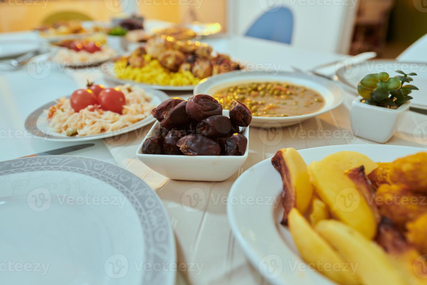 A picturesque array of dates and diverse, delectable dishes adorns the table, creating a sumptuous feast ready for the Iftar meal during the sacred month of Ramadan, embodying a rich tapestry of photo