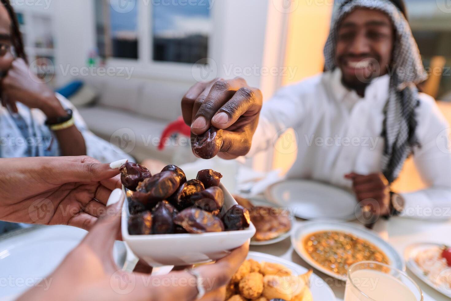 In a poignant close-up, the diverse hands of a Muslim family delicately grasp fresh dates, symbolizing the breaking of the fast during the holy month of Ramadan, capturing a moment of cultural unity photo