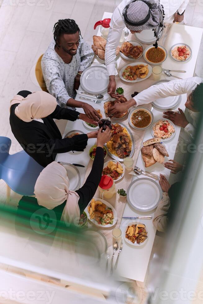 Top view of diverse hands of a Muslim family delicately grasp fresh dates, symbolizing the breaking of the fast during the holy month of Ramadan, capturing a moment of cultural unity, shared tradition photo