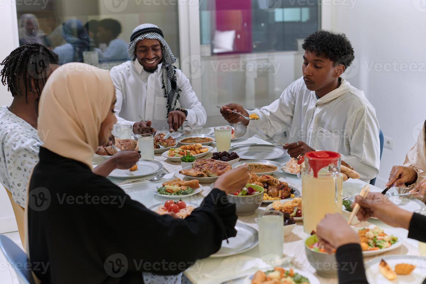 A traditional and diverse Muslim family comes together to share a delicious iftar meal during the sacred month of Ramadan, embodying the essence of familial joy, cultural richness, and spiritual unity photo