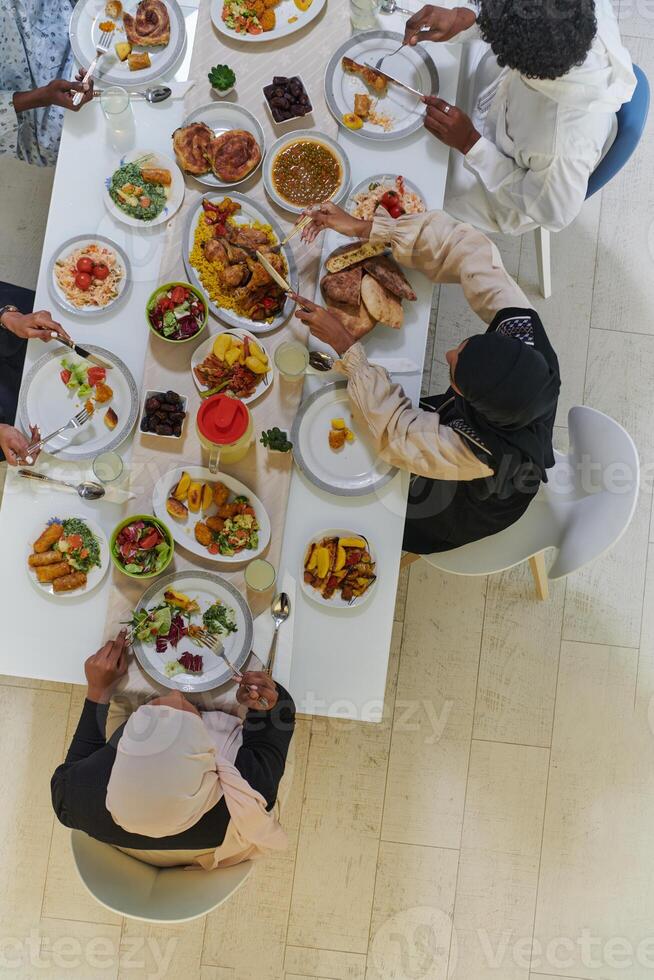 Top view of traditional and diverse Muslim family comes together to share a delicious iftar meal during the sacred month of Ramadan, embodying the essence of familial joy, cultural richness, and photo