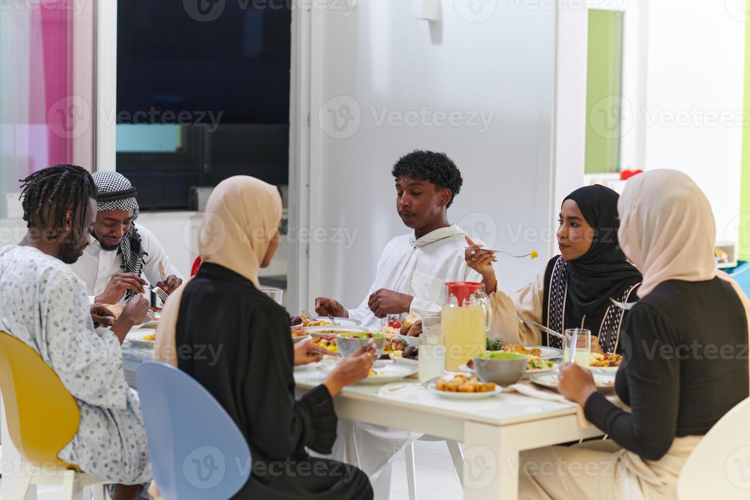 A traditional and diverse Muslim family comes together to share a delicious iftar meal during the sacred month of Ramadan, embodying the essence of familial joy, cultural richness, and spiritual unity photo