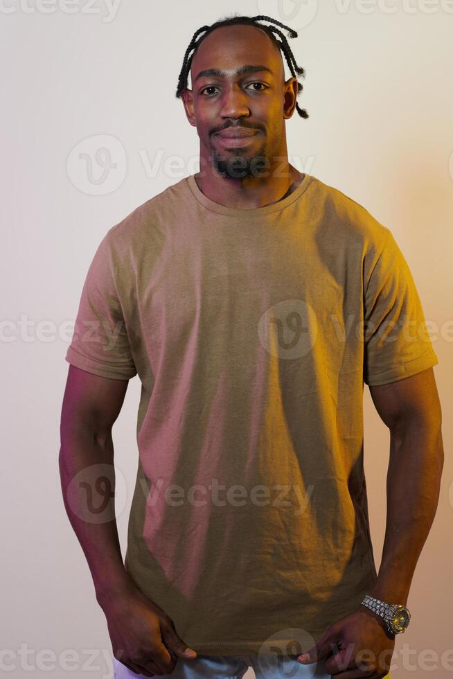 A charismatic and stylish African American man commands attention against a vibrant yellow gel background, showcasing his confident and contemporary fashion sense, radiating charm and sophistication photo
