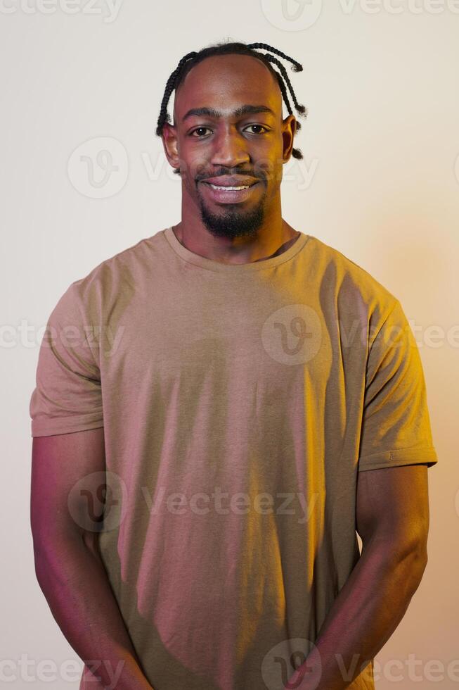 A charismatic and stylish African American man commands attention against a vibrant yellow gel background, showcasing his confident and contemporary fashion sense, radiating charm and sophistication photo