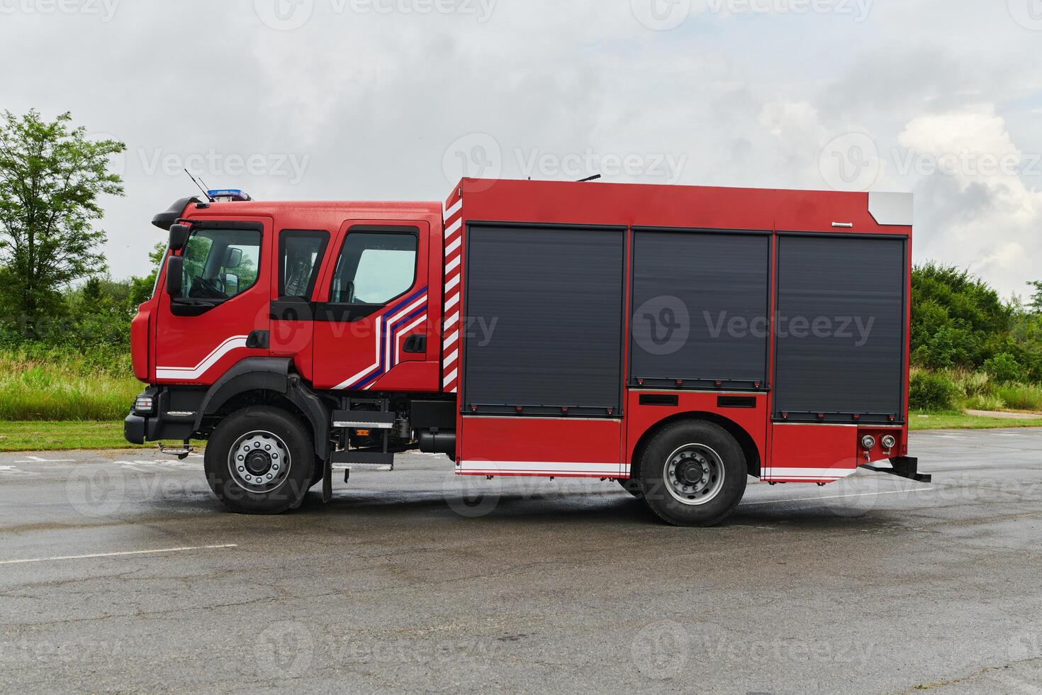 In this captivating scene, a state-of-the-art firetruck, equipped with advanced rescue technology, stands ready with its skilled firefighting team, prepared to intervene and respond rapidly to photo